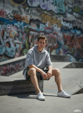 Model sitting while wearing All-Over Print Unisex Athletic Long Shorts