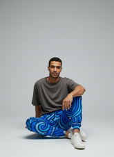Model sitting while wearing Track Pants Urban Print Unisex